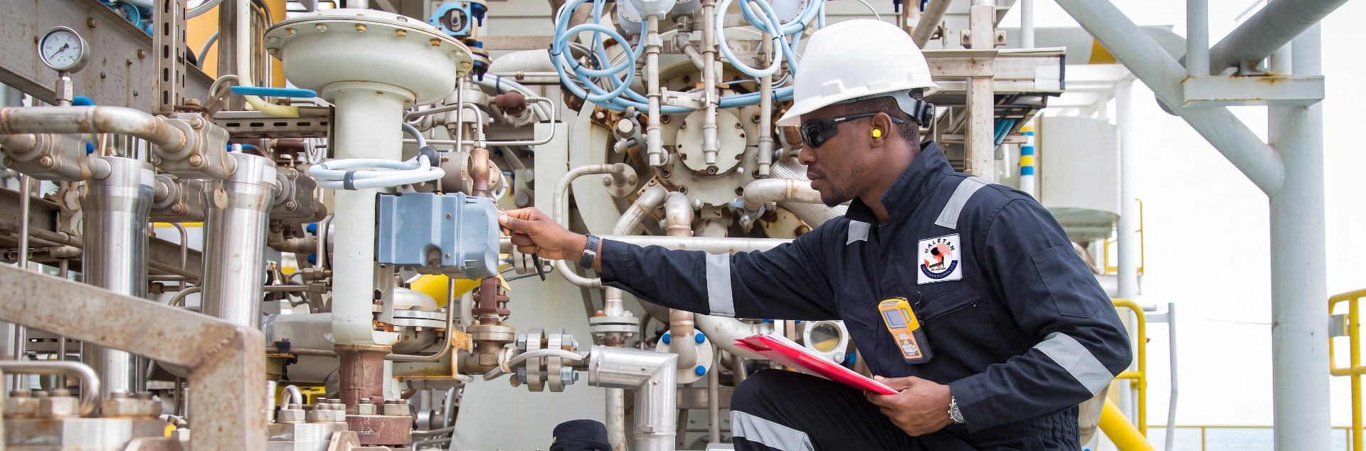 Jaletan technician checking a control valve on offshore process equipment
